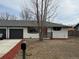 Charming home with a new garage door, modern black accents, and well-kept lawn at 4670 Independence St, Wheat Ridge, CO 80033