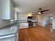 Open kitchen featuring stainless steel appliances, white cabinets, and hardwood floors at 4670 Independence St, Wheat Ridge, CO 80033