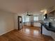 Bright kitchen with stainless steel appliances, white cabinets, and hardwood floors at 4670 Independence St, Wheat Ridge, CO 80033