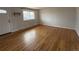 Inviting living room featuring hardwood floors, a large window, and neutral paint at 4670 Independence St, Wheat Ridge, CO 80033
