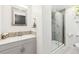 Stylish bathroom with tiled shower, modern vanity, and decorative mosaic tile backsplash at 25 Kendall St, Lakewood, CO 80226