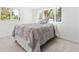 Bright bedroom featuring a large window and stylish duvet for a relaxing and comfortable space at 25 Kendall St, Lakewood, CO 80226