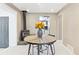 Cozy dining area with a rustic wood-burning stove, charming circular table, and kitchen view at 25 Kendall St, Lakewood, CO 80226