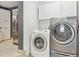Convenient laundry room with washer, dryer, and ample storage, plus stainless refrigerator at 25 Kendall St, Lakewood, CO 80226