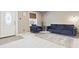 Bright living area with new carpeting, comfortable blue furniture, and a decorative window at 25 Kendall St, Lakewood, CO 80226
