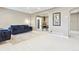 Cozy living room featuring plush blue seating, light carpet, and an open archway at 25 Kendall St, Lakewood, CO 80226