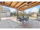 Enjoy the outdoor living on this covered patio with dining set, ceiling fan, and backyard view at 25 Kendall St, Lakewood, CO 80226