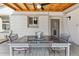 Covered outdoor dining area with a rustic wood ceiling, and outdoor lighting fixture at 25 Kendall St, Lakewood, CO 80226