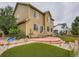 Exterior view of home featuring a red brick patio, artificial turf, and fenced yard at 5553 Jasper St, Denver, CO 80239