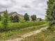 View of community's open space from backyard with a walking path in the foreground at 5553 Jasper St, Denver, CO 80239