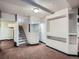 Spacious finished basement area with stairs, recessed lighting, and built in shelves at 5553 Jasper St, Denver, CO 80239
