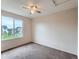 Bright bedroom with carpet flooring and a window offering views of the outdoors at 5553 Jasper St, Denver, CO 80239