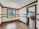 Dining room with hardwood floors, decorative wood trim, and views to the kitchen with granite countertops at 5553 Jasper St, Denver, CO 80239
