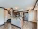 Kitchen with wood floors, island with marble countertops, stainless steel appliances at 5553 Jasper St, Denver, CO 80239