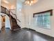Inviting living room featuring dark marble floors, large windows, and a staircase leading to the second level at 5553 Jasper St, Denver, CO 80239