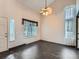 Living room with high ceilings, tile floors, ceiling fan, and bright windows at 5553 Jasper St, Denver, CO 80239