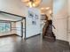 Spacious living room with tile floors, ceiling fan, wooden staircase, and staircase at 5553 Jasper St, Denver, CO 80239