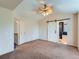 Spacious primary bedroom with a ceiling fan and a sliding barn door to the bathroom at 5553 Jasper St, Denver, CO 80239
