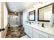 Bathroom featuring a double vanity, shower, and modern fixtures at 2177 Shadow Creek Dr, Castle Rock, CO 80104
