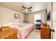Cozy bedroom features a comfortable bed, ceiling fan, and natural light from the window, creating a relaxing atmosphere at 2177 Shadow Creek Dr, Castle Rock, CO 80104