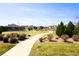 Picturesque park view within a residential community, featuring trees and walking paths at 2177 Shadow Creek Dr, Castle Rock, CO 80104