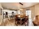 Open-concept dining area with a large wooden table, stylish lighting, and seamless access to the kitchen at 2177 Shadow Creek Dr, Castle Rock, CO 80104