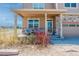 Inviting front porch with decorative stone accents, comfortable seating, and a warm welcome sign at 2177 Shadow Creek Dr, Castle Rock, CO 80104