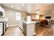 Open concept kitchen features an island, modern appliances, and seamless transition to the dining and living area at 2177 Shadow Creek Dr, Castle Rock, CO 80104