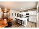 Spacious kitchen showcasing an island, farmhouse-style cabinets, and a view to the front entry at 2177 Shadow Creek Dr, Castle Rock, CO 80104