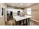 Bright kitchen features an island with seating, stainless steel appliances, and white cabinetry at 2177 Shadow Creek Dr, Castle Rock, CO 80104