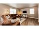 Comfortable living room with a large sectional sofa, coffee table, and a media center at 2177 Shadow Creek Dr, Castle Rock, CO 80104