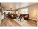 Open-concept living room showcases a seamless flow from the kitchen to the dining area at 2177 Shadow Creek Dr, Castle Rock, CO 80104
