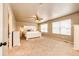 Spacious main bedroom with ample natural light, neutral tones, and a ceiling fan for comfort at 2177 Shadow Creek Dr, Castle Rock, CO 80104