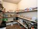 Well-organized pantry with wooden shelving and an array of food items, maximizing storage space at 2177 Shadow Creek Dr, Castle Rock, CO 80104