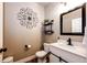 Stylish powder room featuring modern fixtures, a decorative mirror, and a clean, contemporary design at 2177 Shadow Creek Dr, Castle Rock, CO 80104