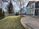 View of the lush green lawn and a view of the home's backyard, patio, and fire pit in the distance at 1618 Garnet St, Broomfield, CO 80020