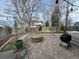 Backyard view showcasing a stone fire pit, barbecue grill, and a well-maintained lawn and garden at 1618 Garnet St, Broomfield, CO 80020