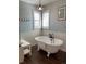 Bathroom with a freestanding tub, wainscoting, and natural light at 1618 Garnet St, Broomfield, CO 80020