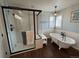 Bathroom featuring a freestanding tub and walk-in shower with a glass enclosure at 1618 Garnet St, Broomfield, CO 80020