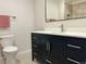 Bathroom featuring a dark vanity with white countertops at 1618 Garnet St, Broomfield, CO 80020