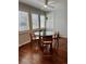 Bright dining area featuring a round glass table, four wooden chairs, and ample natural light from the surrounding windows at 1618 Garnet St, Broomfield, CO 80020