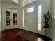 Bright entryway with hardwood floors, decorative glass door, and adjacent office through glass French doors at 1618 Garnet St, Broomfield, CO 80020