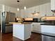 Bright kitchen featuring white cabinets, stainless steel refrigerator, and a butcher block island with dark countertops at 1618 Garnet St, Broomfield, CO 80020