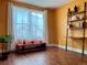 Bright living room with wood floors, shelving, large window with sheer curtains at 1618 Garnet St, Broomfield, CO 80020