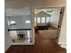 A view of the main bedroom from the landing, with high ceilings, windows, and a comfortable chair at 1618 Garnet St, Broomfield, CO 80020