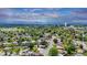 Aerial view of a home nestled in a lush, green neighborhood with mountain views in the distance at 8259 Nola Dr, Denver, CO 80221