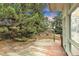 Backyard patio with wooden deck, beautiful landscaping, and lush green trees, offering a peaceful retreat at 8259 Nola Dr, Denver, CO 80221