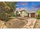 Charming backyard featuring stone pathway, brick accents, and a sunroom, perfect for outdoor enjoyment at 8259 Nola Dr, Denver, CO 80221