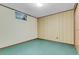 Finished basement with striped walls and green carpet at 8259 Nola Dr, Denver, CO 80221