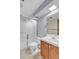 Bathroom featuring a shower, toilet, vanity, and mirror at 8259 Nola Dr, Denver, CO 80221